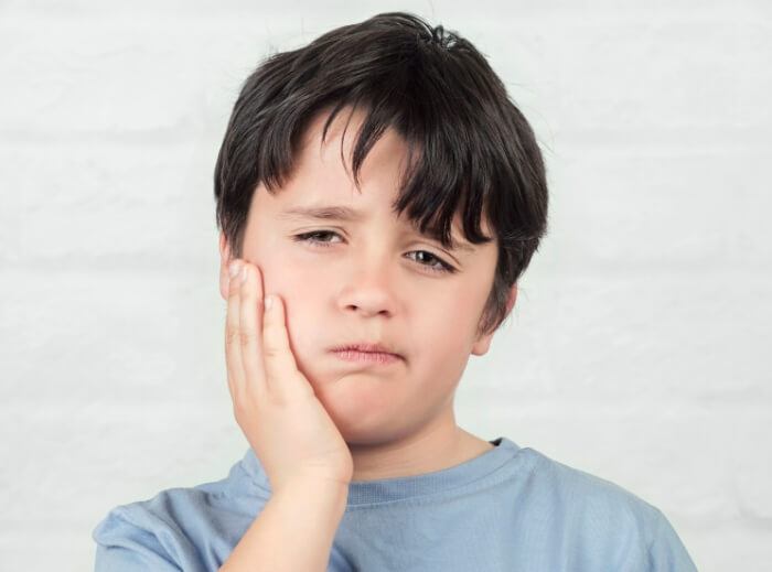 Child in pain before emergency kids' dentistry