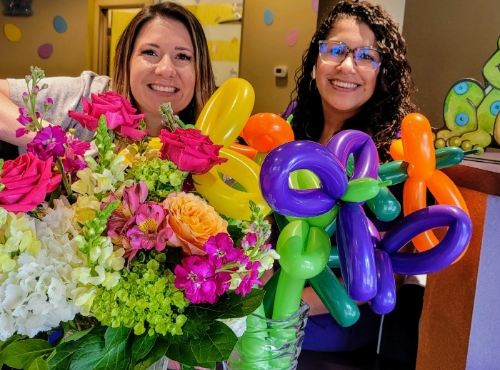 Two friendly dental team members smiling together