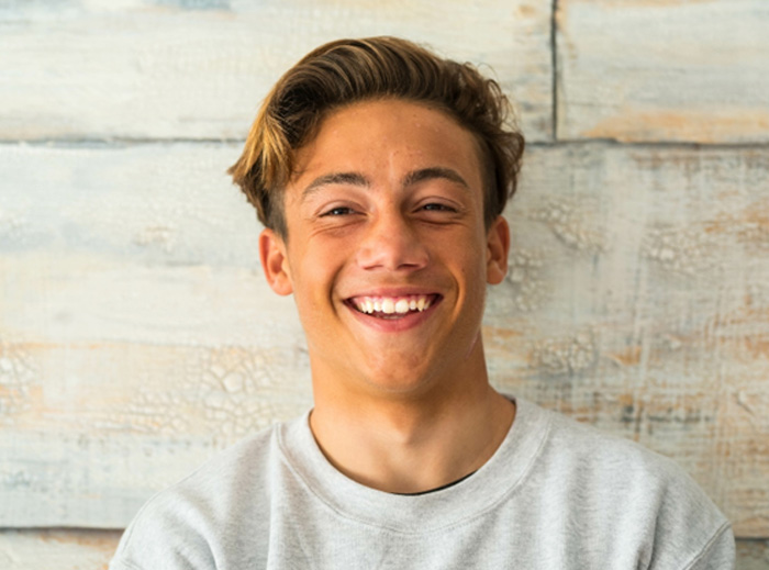 Teenage male smiling with cavity-free grin 