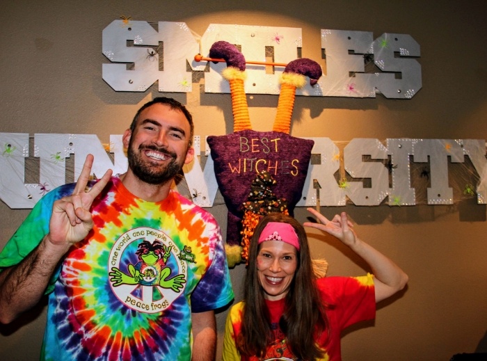 Two smiling dental team members wearing costumes