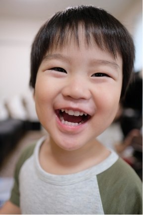 Young child sharing healthy smile after restorative dentistry