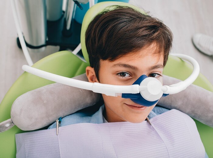Child receiving nitrous oxide sedation dentistry treatment