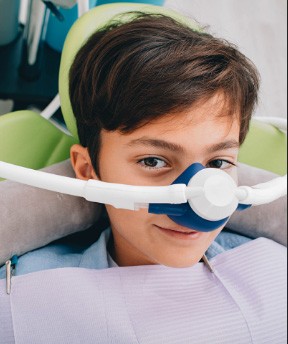 Child receiving nitrous oxide sedation dentistry treatment