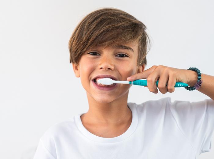 young boy brushing teeth 