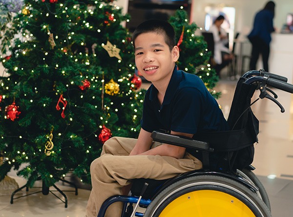 Boy in a wheelchair and smiling