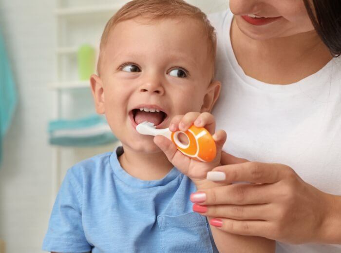 Baby smiling while receiving dentistry for infants