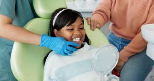 little girl smiling with a new dental crown